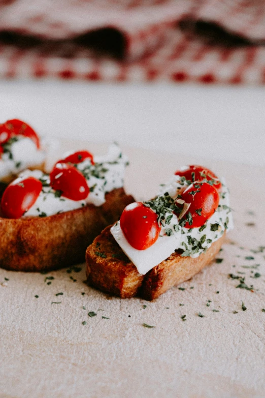 slices of toast with whipped cream and cherry tomatoes