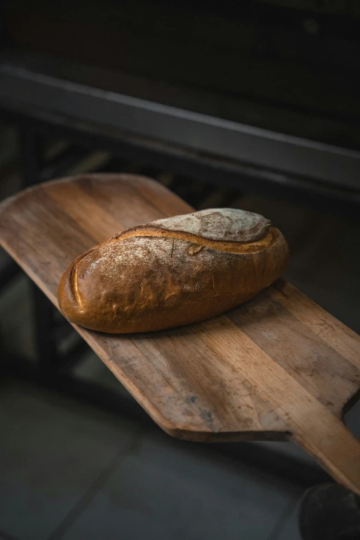 an oval loaf of bread on a  board