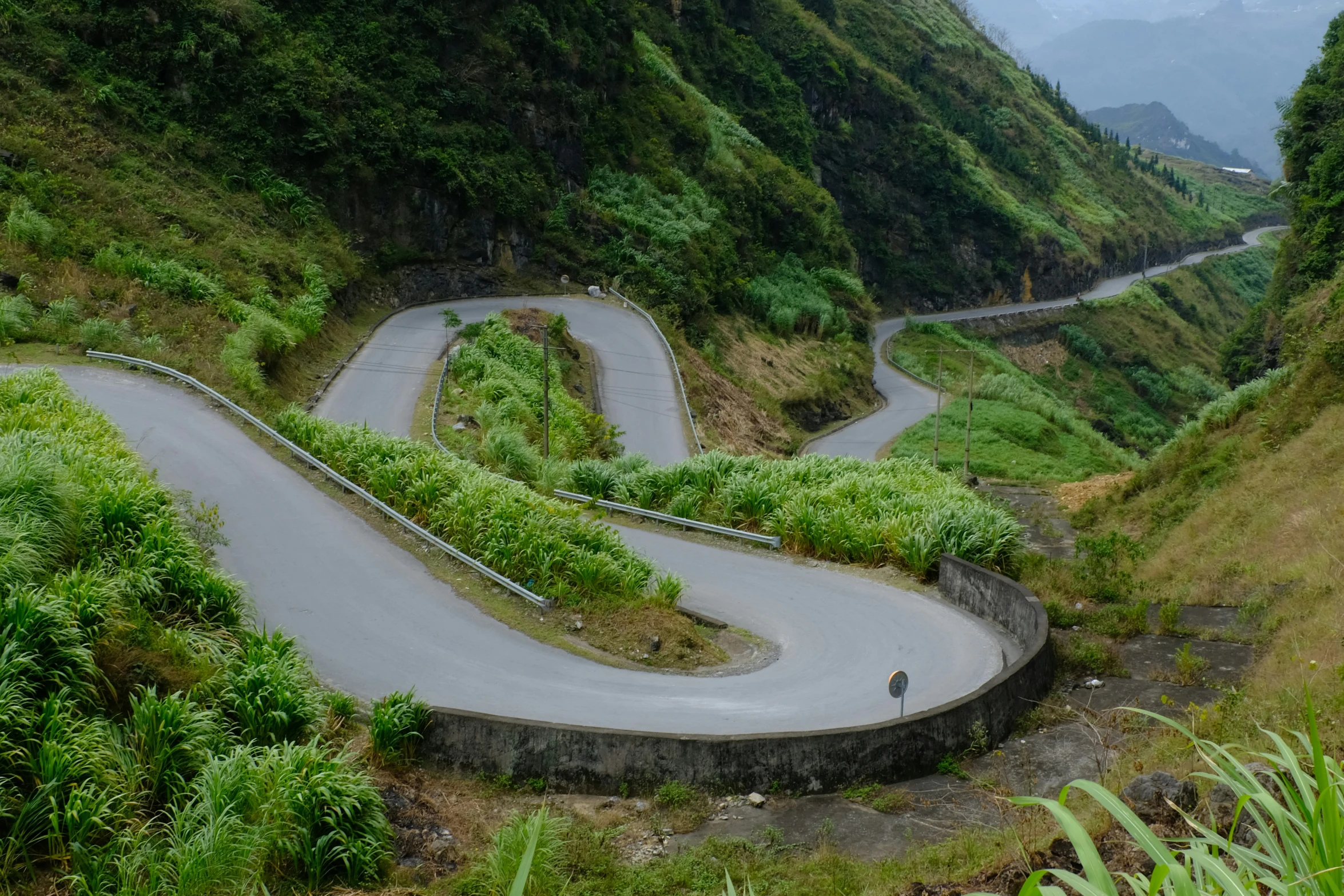 a winding road on the side of a mountain side