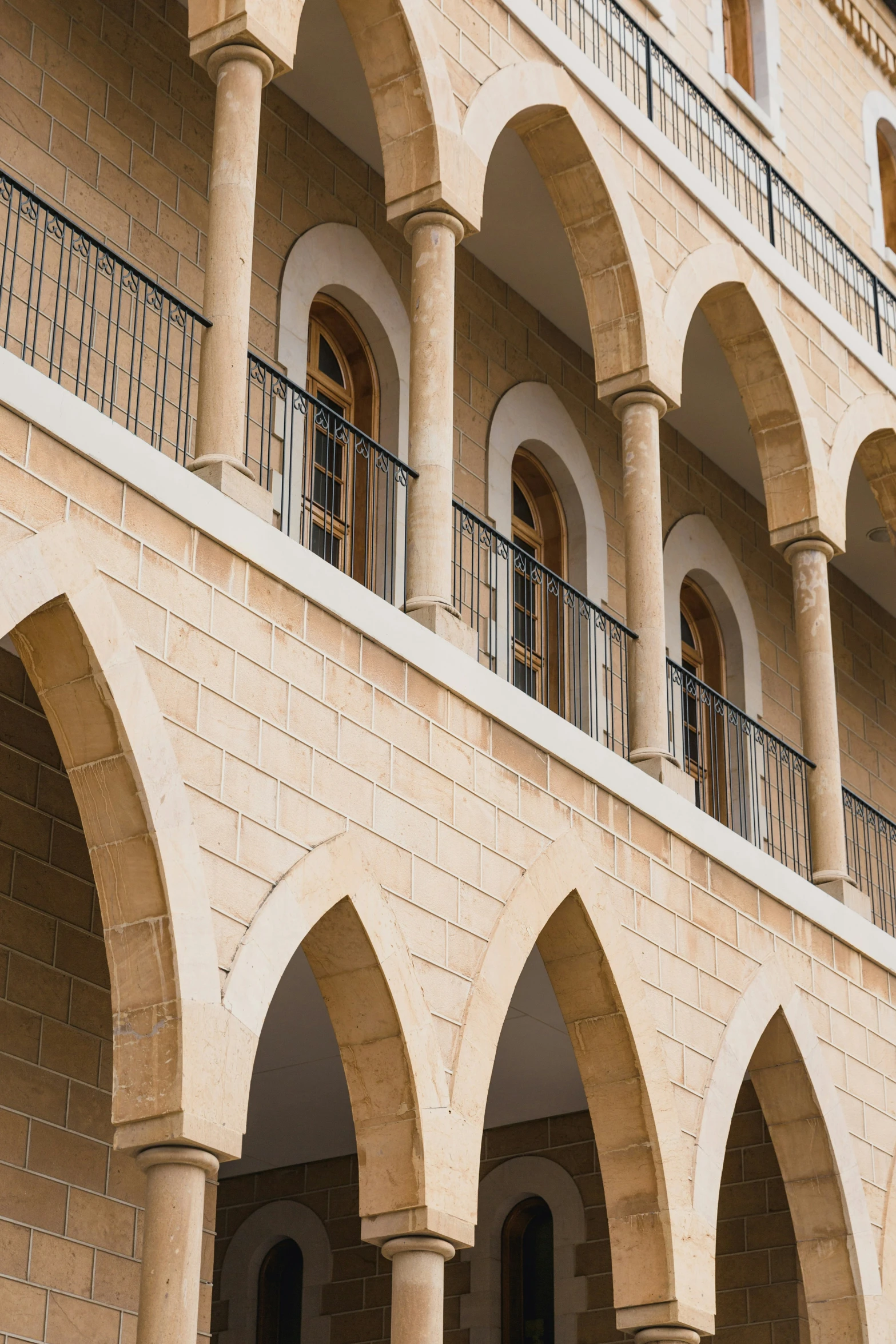 several arches and balconies on the side of a building