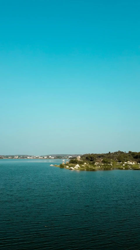 two large sail boats in the ocean near the shore