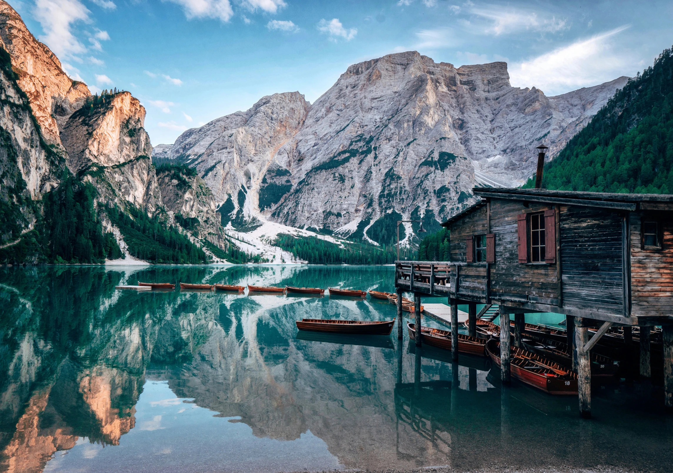 a wooden cabin sitting next to some water