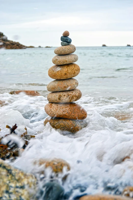 a rock tower sitting on top of a body of water