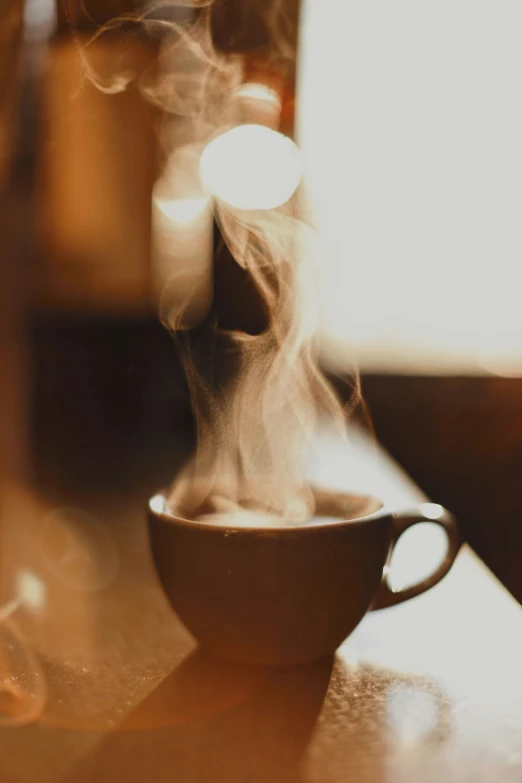 steam rising from top of coffee cup on table