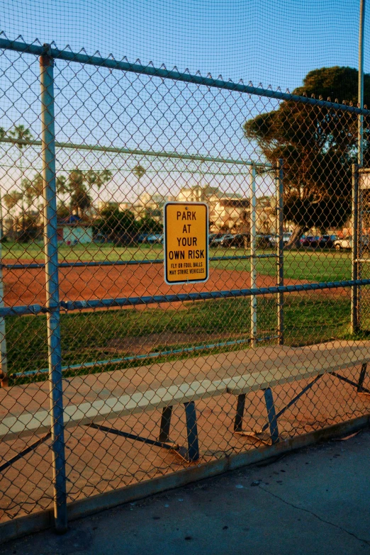 a sign warns people of the dangerous rules for baseball