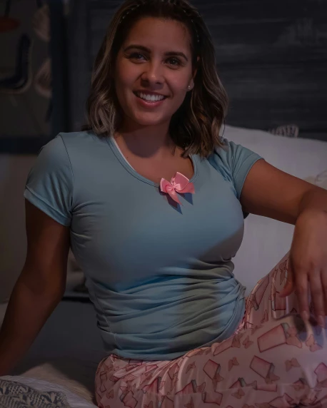 woman in pink top holding a pink and white bow