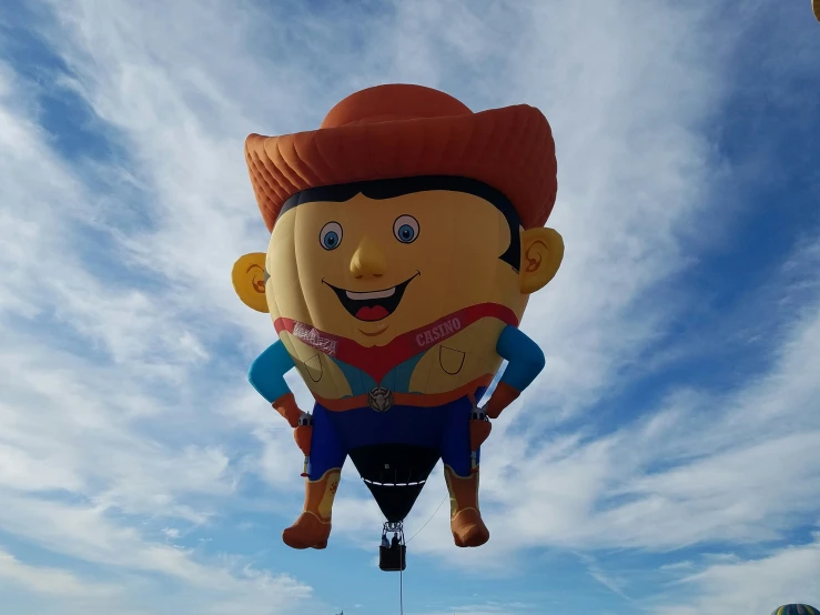 the man is riding on a parachute that is in the sky
