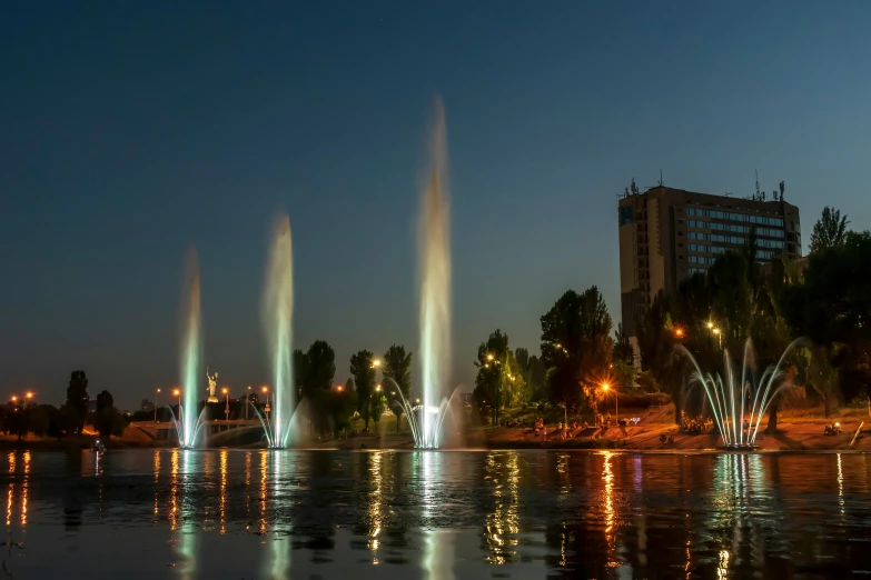 many fountain displays are lit up with colorful lights