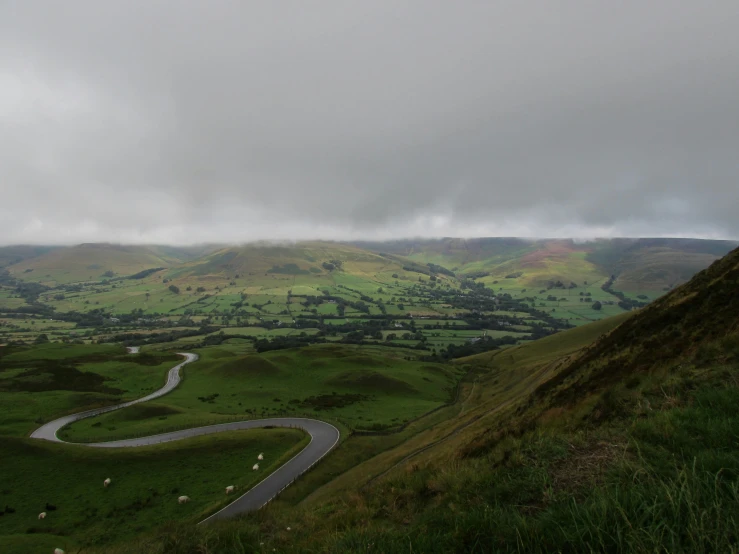 a winding road in a lush green landscape