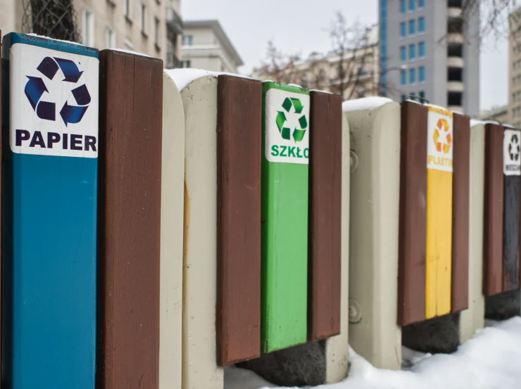 several rows of colorful wooden fence with paper symbols