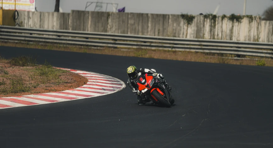 a man riding a motorcycle down the side of a race track