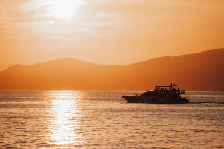 a boat in the water on the ocean at sunset