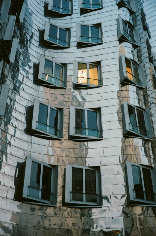 the facade of an old brick building shows windows and shutters