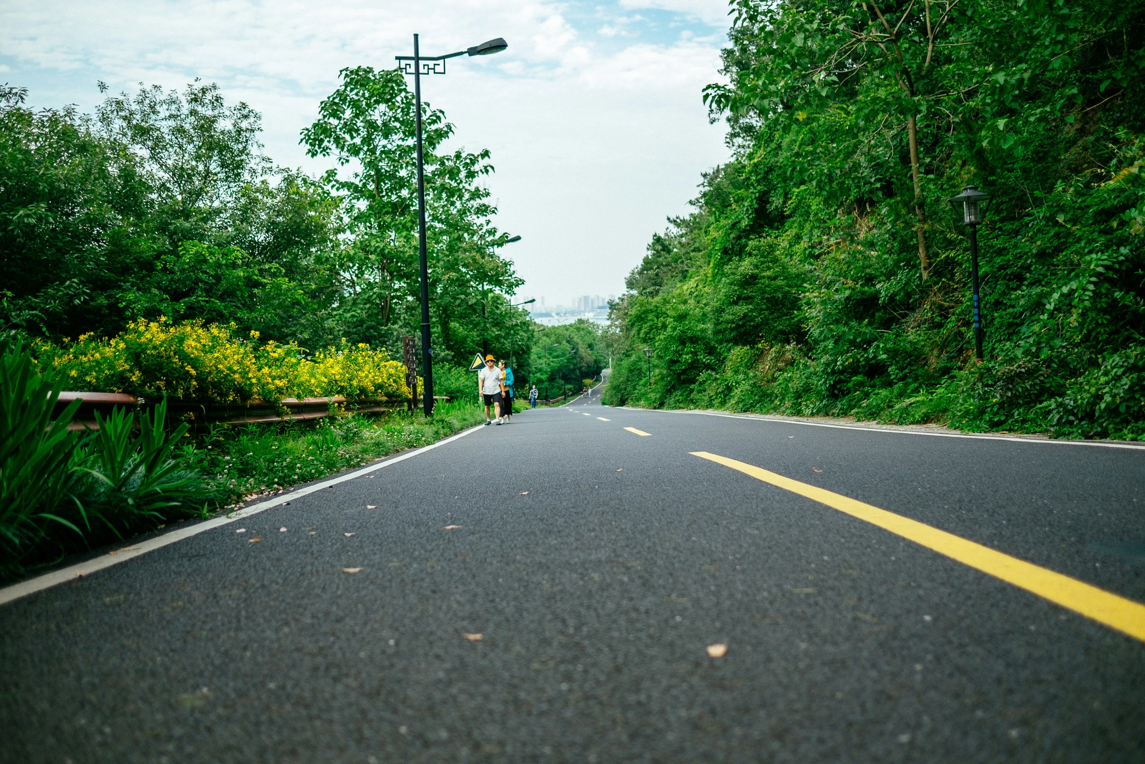 a person walks along the side of a deserted road