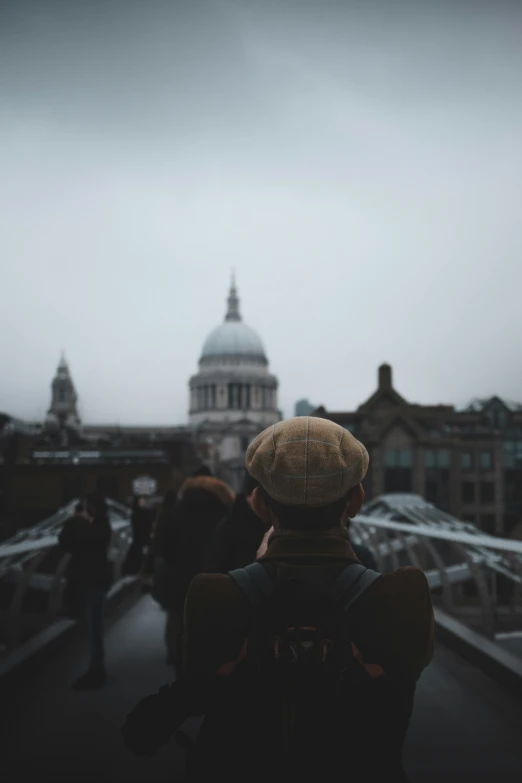 a person in a hat is looking at the sky