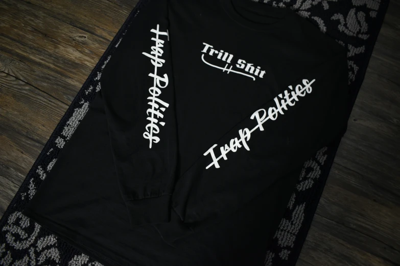 a black long sleeve t - shirt with white lettering
