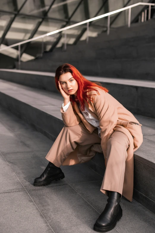 a woman sitting on steps with her head down