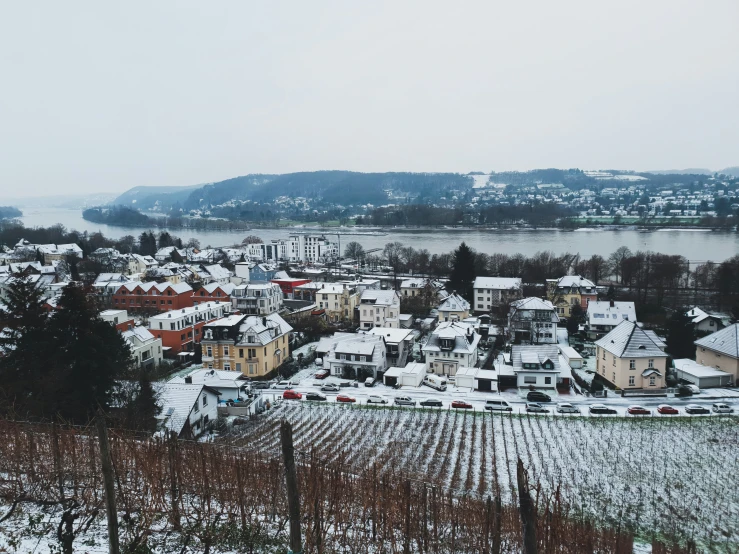 snow - covered village perched over a vineyard in the countryside