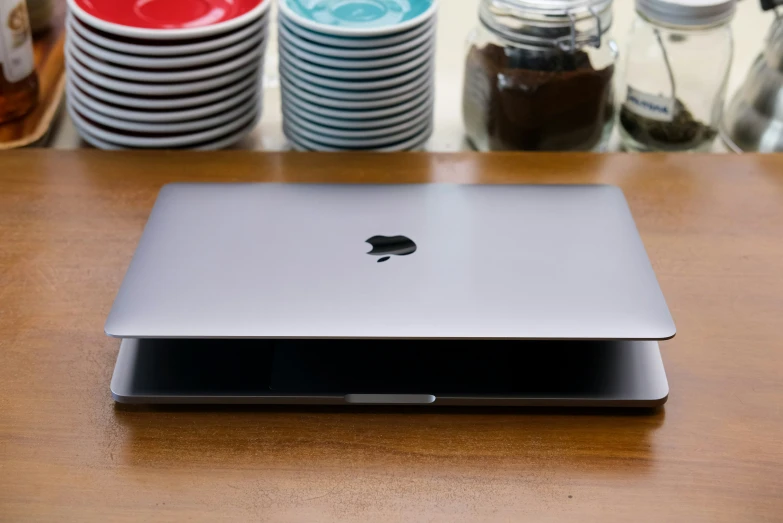 an apple computer sitting on top of a wooden table