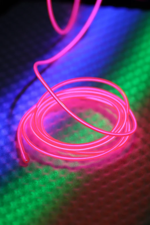 a neon light with pink and green wire