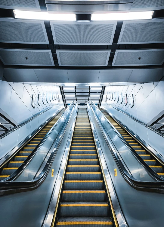 an escalator with three sets of stairs in a building