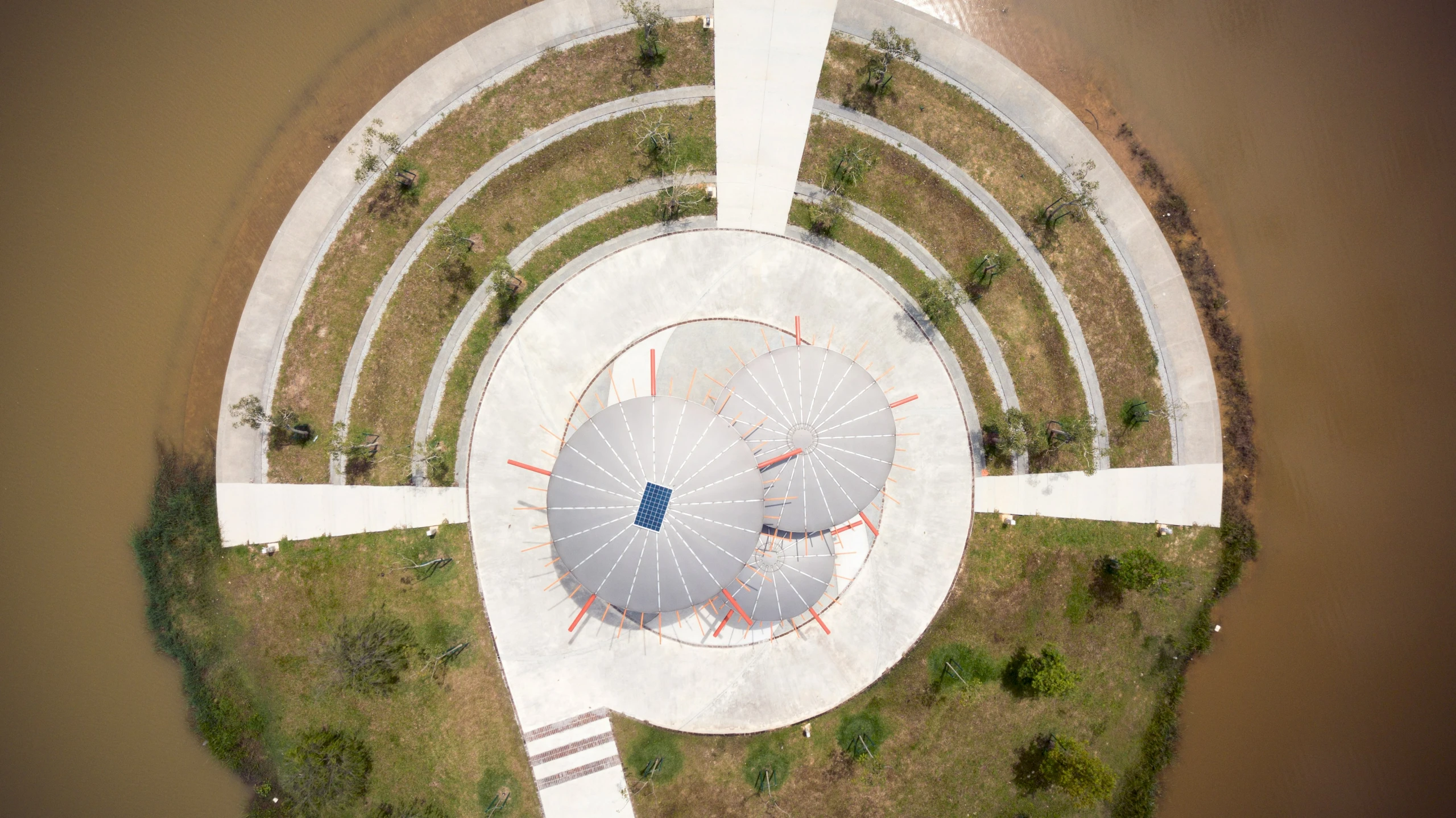 an aerial view of a circular concrete structure in a park