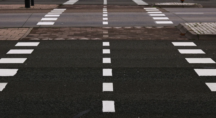 an empty crosswalk is shown in a quiet city