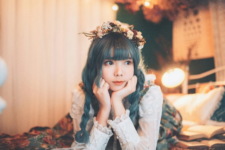girl wearing flowers sitting on her head in the middle of bed
