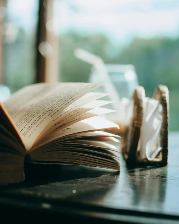 an open book with a pair of scissors on the table next to it