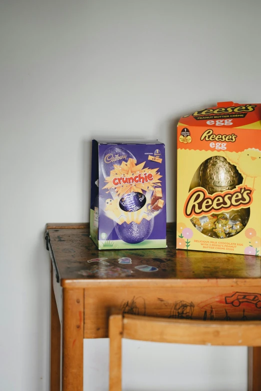 two boxes of cereal sitting on top of a table