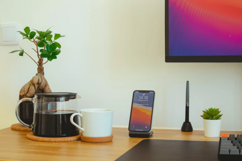 the wooden table with items on it is near a cell phone