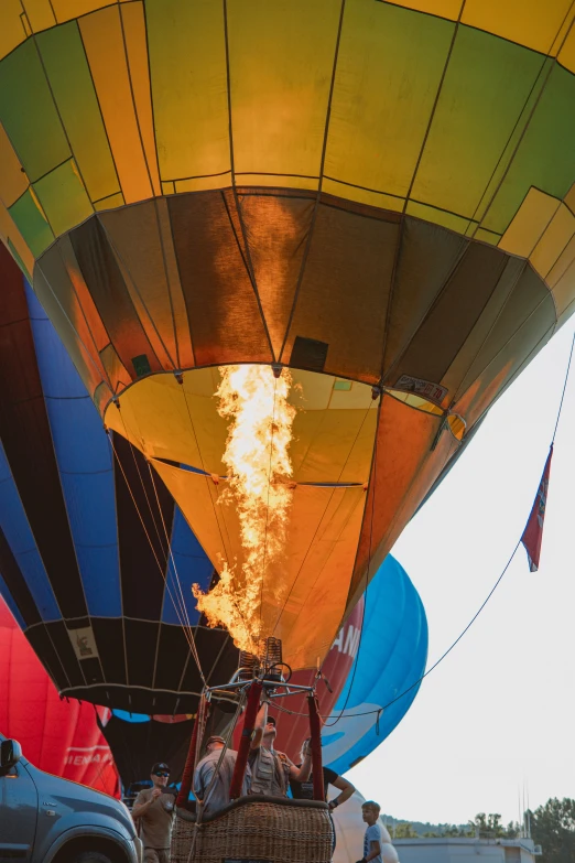 colorful balloons being inflated in a field with people