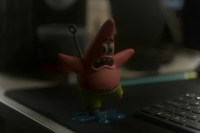 a cartoon figure sitting in front of a computer keyboard
