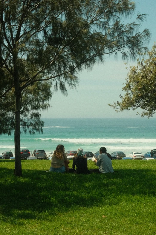 a group of people sitting on a bench near water