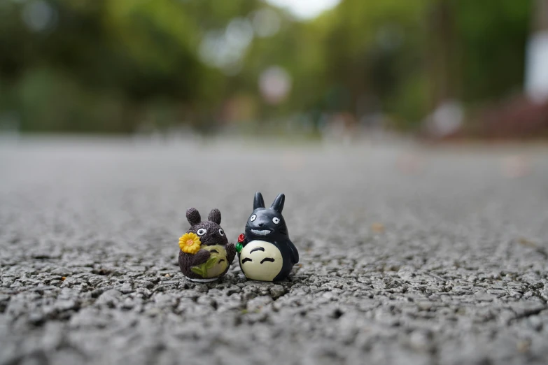 two toy characters sitting in the middle of a road