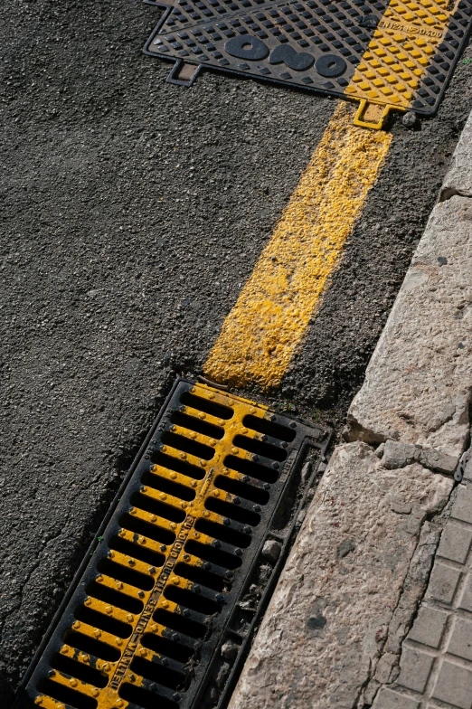 a yellow and black fire hydrant on the sidewalk