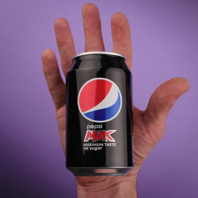 an image of hand holding an empty soda can