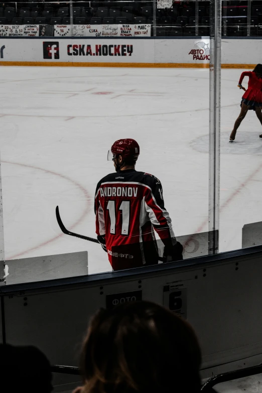 a man on a hockey team in the middle of an ice rink