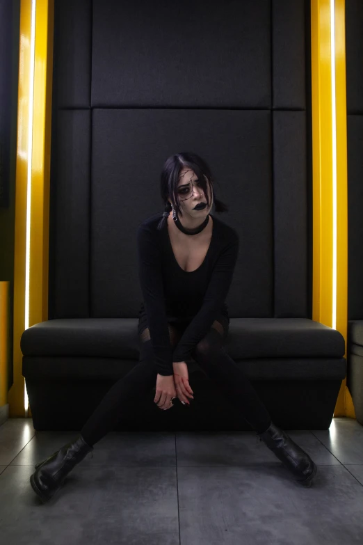 a woman with face paint on, posing in black clothing