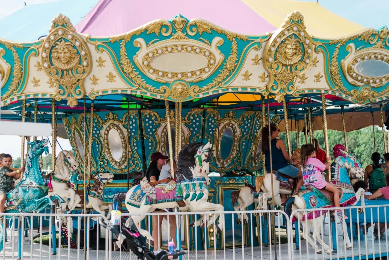 a carousel in the middle of the park with lots of people