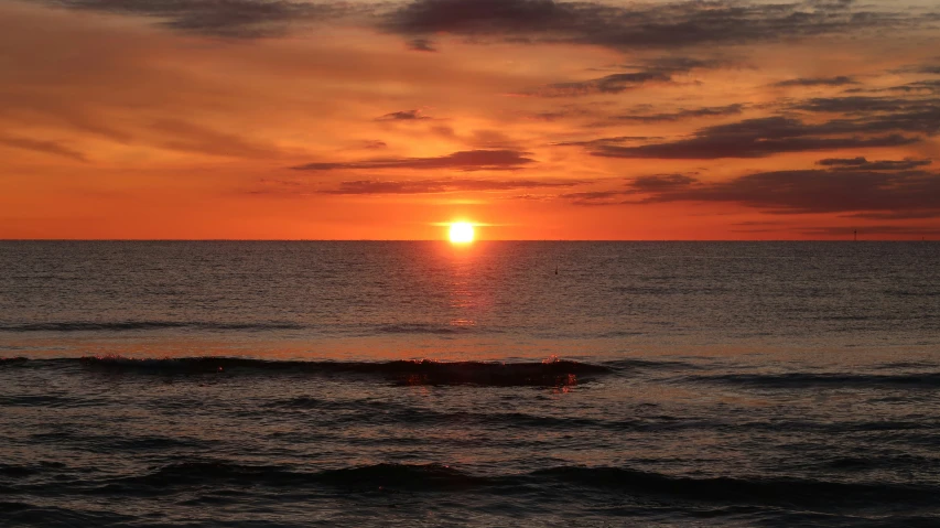 a beautiful sunset that is setting over the ocean