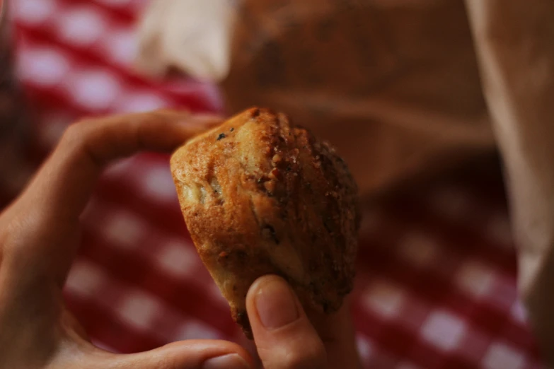 a person holding onto some type of pastry