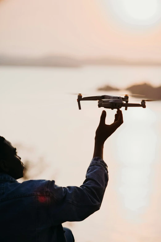 a man holding a model of a flying object