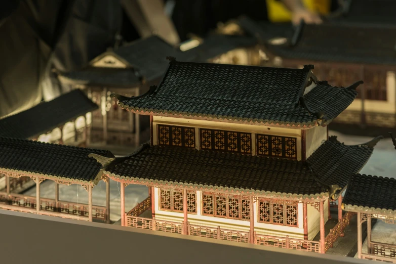 small model of building with roof tops in lit area