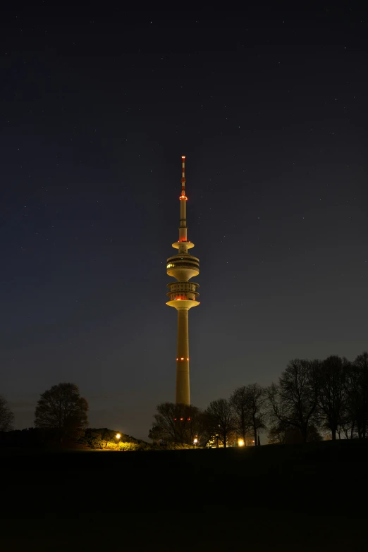 the night time sky view of a tall building