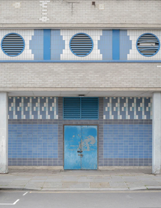 the blue door is closed by the gray wall