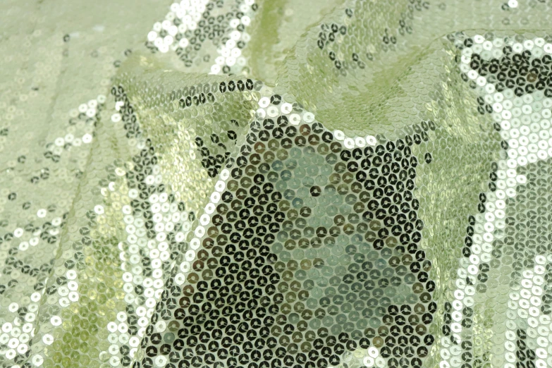 the back side of a curtain with some green colored sequins