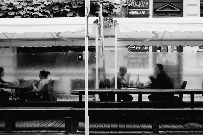 a couple sitting at an outside table talking