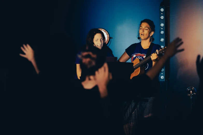 a group of people that are standing up with guitars