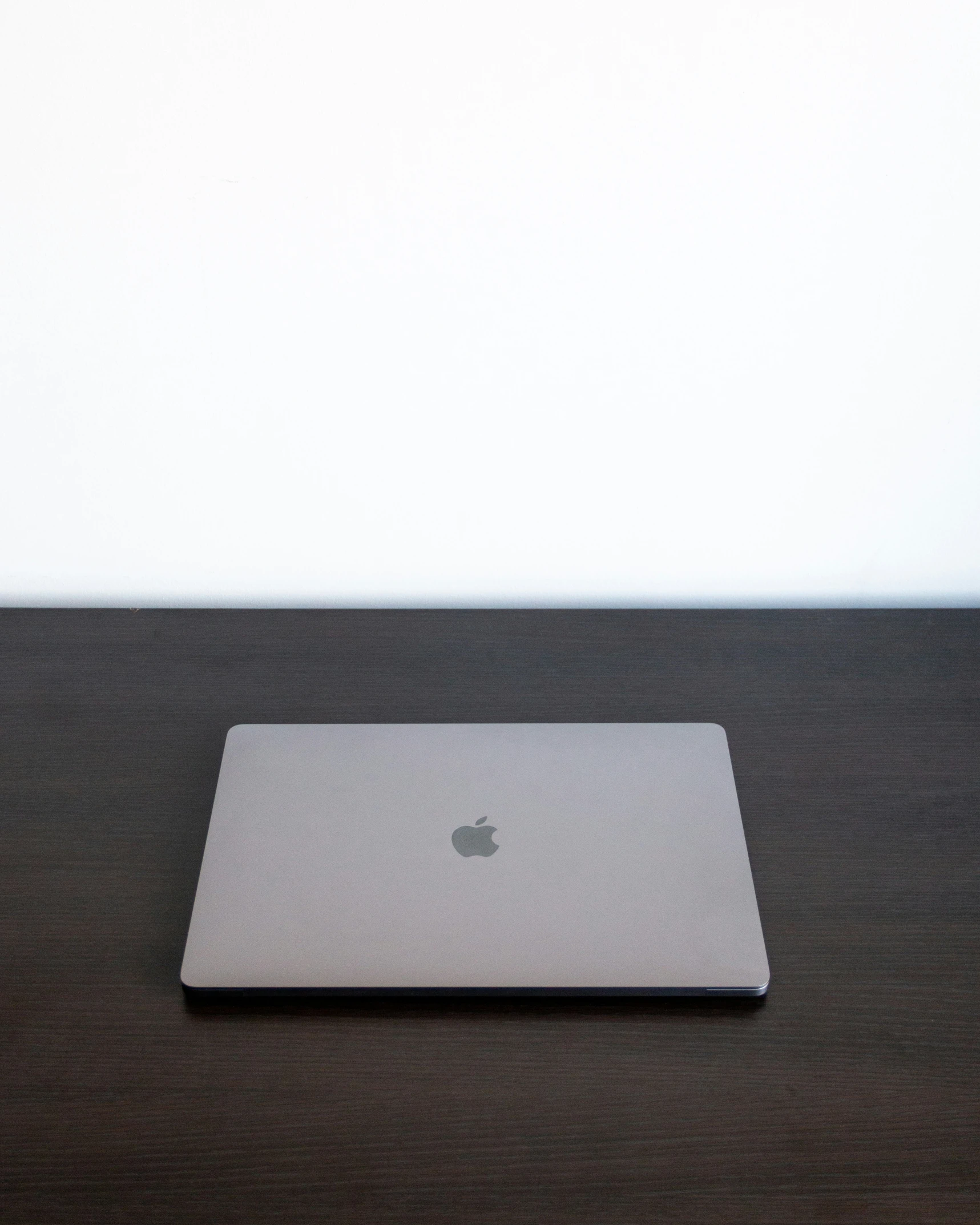 an apple laptop with a mac logo on a desk